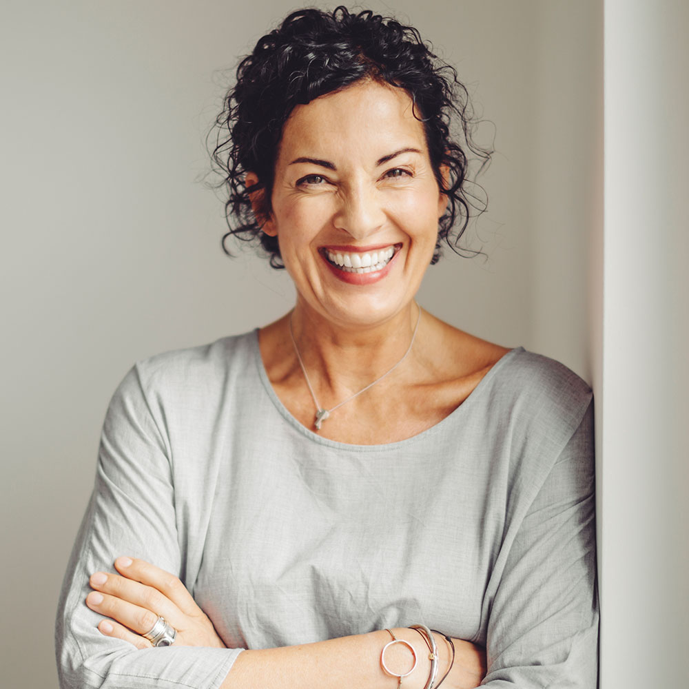 Smiling woman at dental implant office in Downey